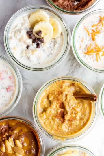 Various flavors of overnight oats in jars on a countertop