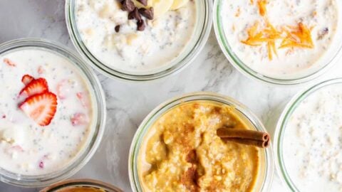 Various flavors of overnight oats in jars on a countertop