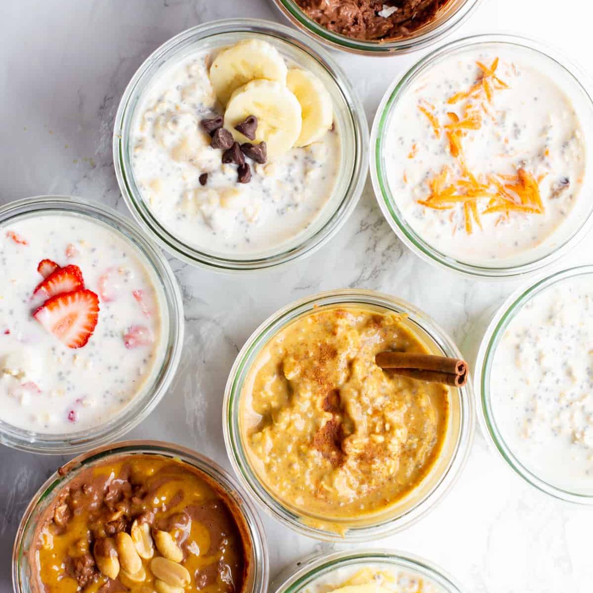 Various flavors of overnight oats in jars on a countertop