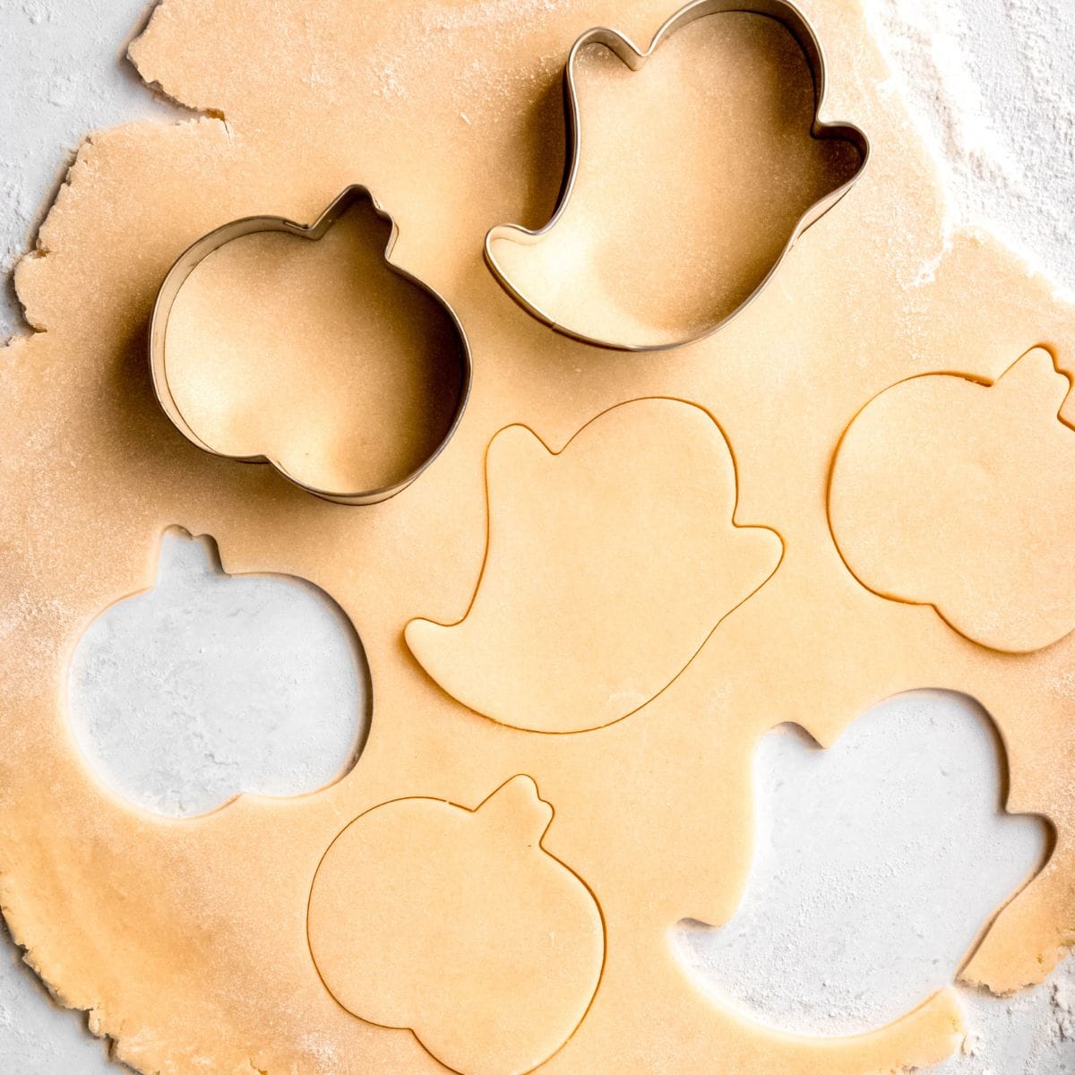 Cutting out ghost and pumpkin shapes using cookie cutters