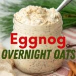 A spoon sticks out of a small jar of creamy eggnog oats. A text overlay reads, "Eggnog Overnight Oats."