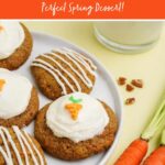 Close view of carrot cookies on a white plate with fresh carrots, pecan pieces, and milk nearby. A text overlay reads, "Carrot Cake Cookies. Perfect Spring Dessert!"