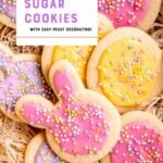 Close view of cookies in bunny and egg shapes with pastel pink, yellow, and purple frosting, topped with colorful nonpareils sprinkles. A text overlay reads, "Make with the Kids! Easter Sugar Cookies with Easy-Peasy Decorating!"