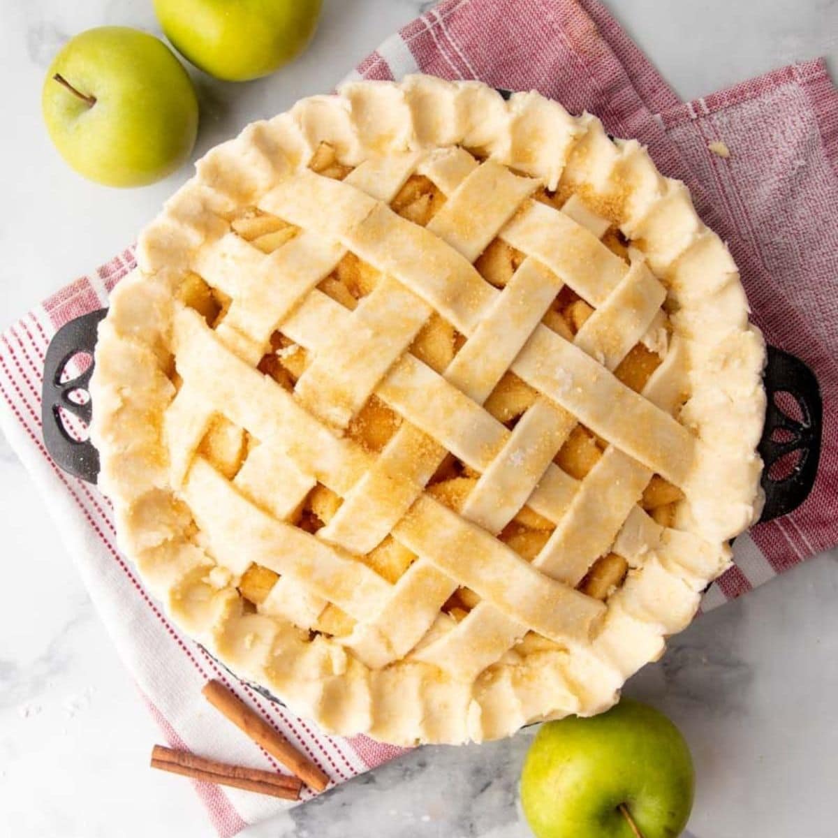 Sugar sprinkled over an unbaked pie with lattice crust