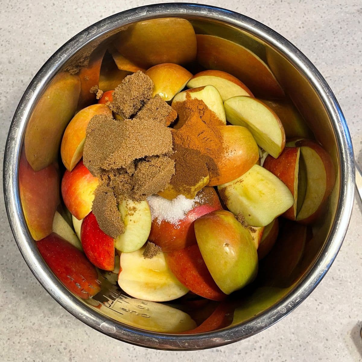 Brown sugar and spices on top of chopped apples