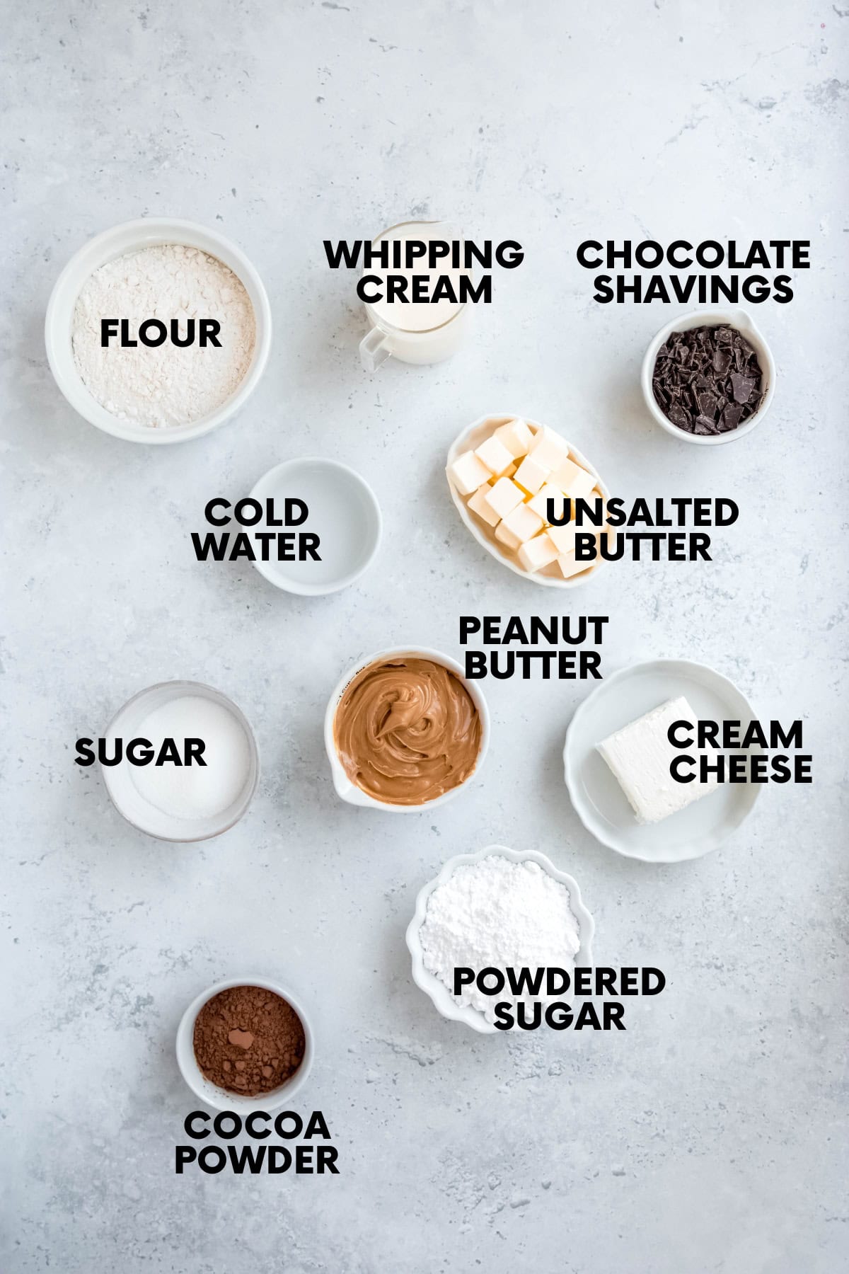 Ingredients for a chocolate peanut butter pie: flour, whipping cream, chocolate shavings, cold water, unsalted butter, sugar, peanut butter, cream cheese, powdered sugar, cocoa powder.
