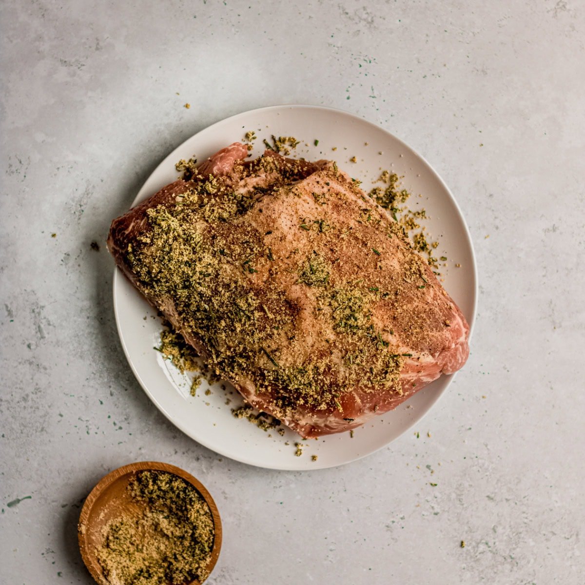 Dry rub on a pork shoulder.
