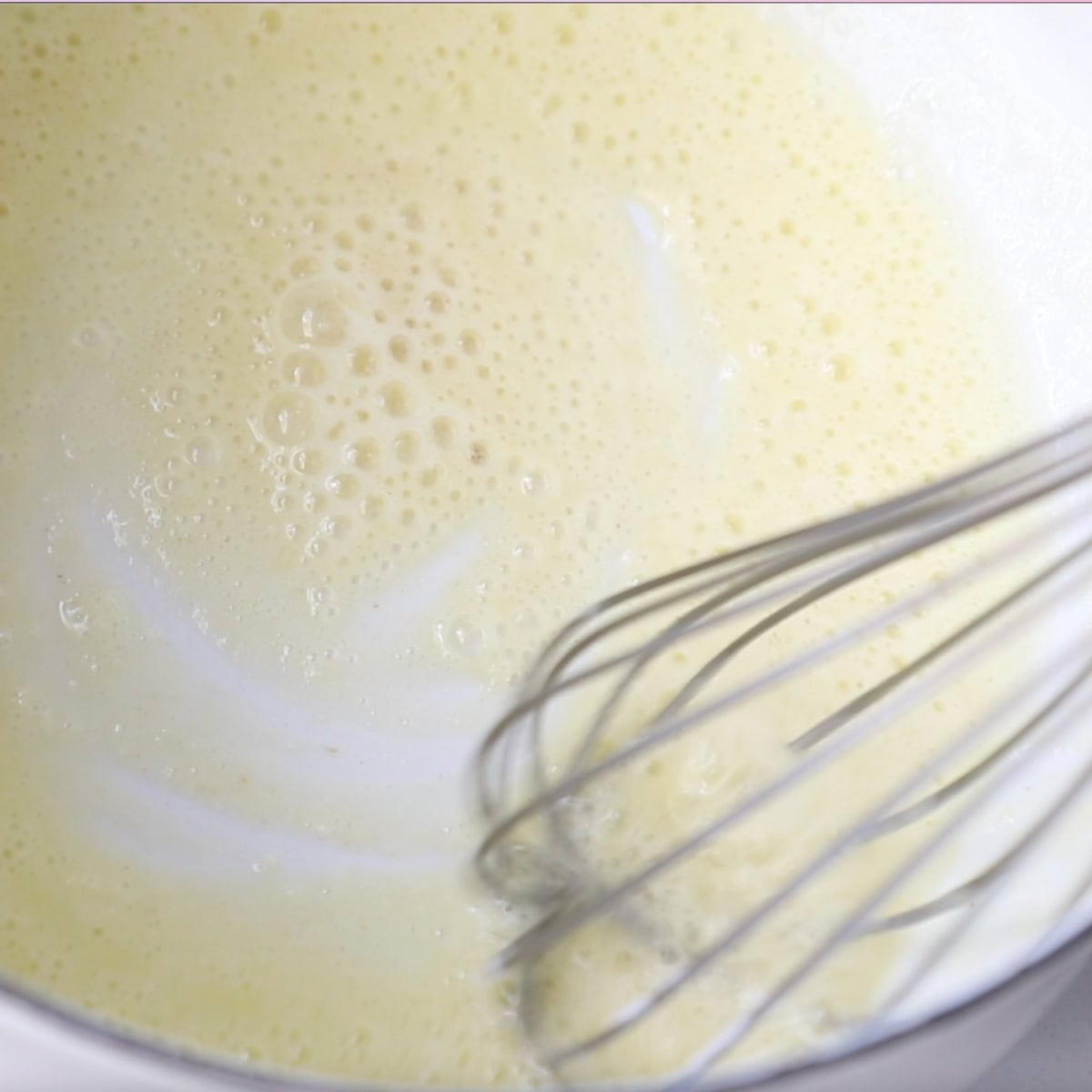 A whisk stirs a roux for turkey gravy.