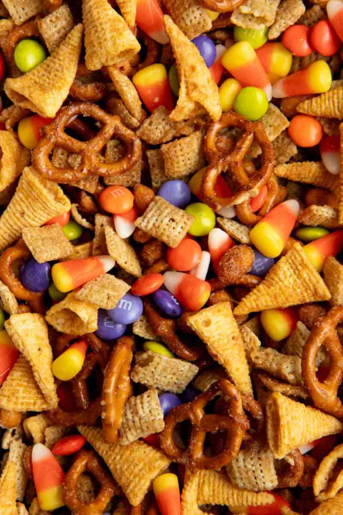 Halloween Chex Mix with Halloween chocolate candies and candy corn