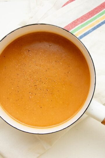 Homemade turkey gravy seasoned with salt and pepper, in a pot.