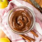 Instant Pot apple butter in a glass jar on top of a dish towel