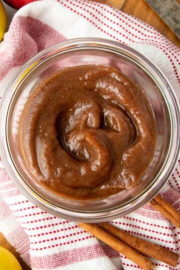 Instant Pot apple butter in a glass jar on top of a dish towel