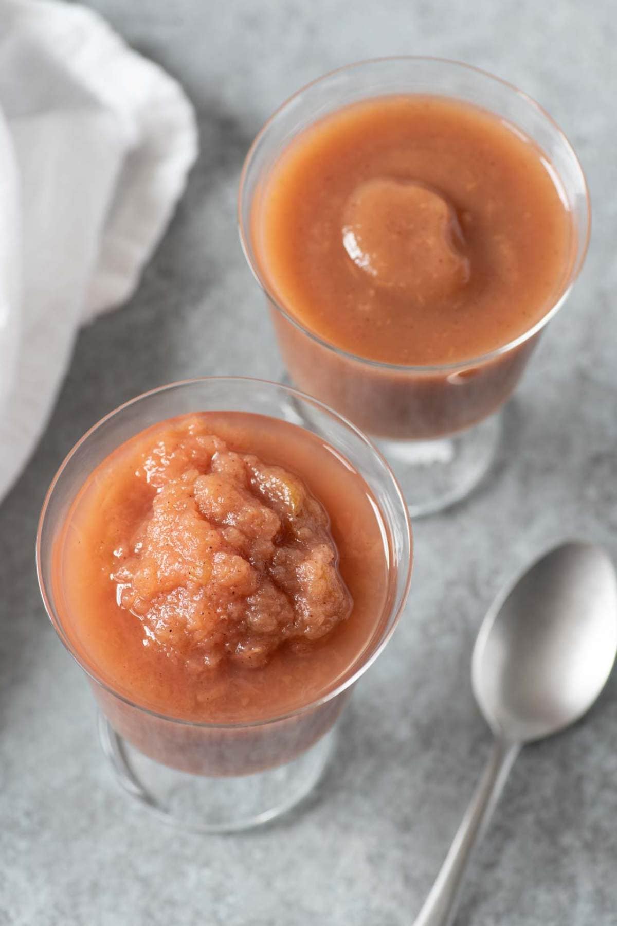 Two glass dishes of pink-colored applesauce