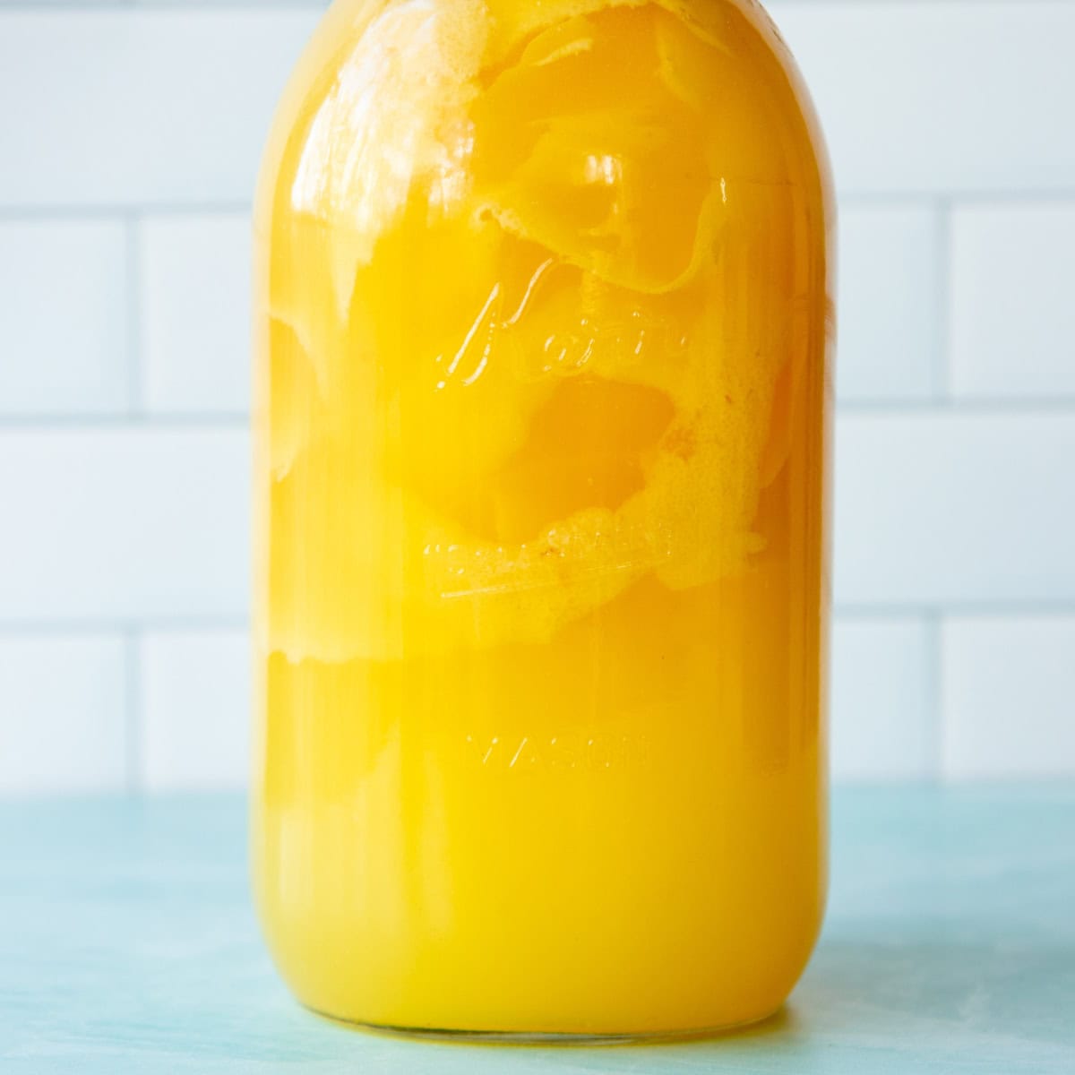 Jar of limoncello infusion after adding simple syrup.