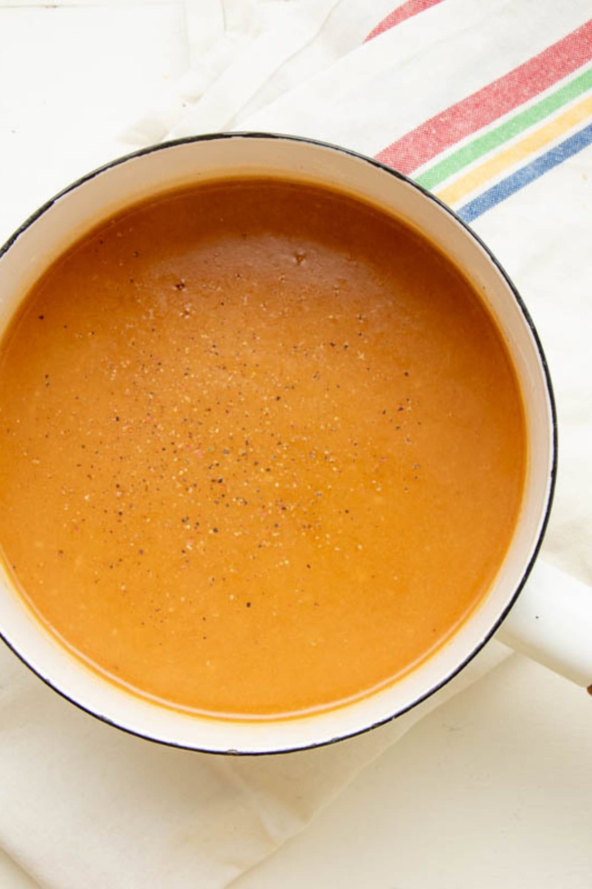 A pot of gravy from turkey drippings, seasoned with salt and pepper.