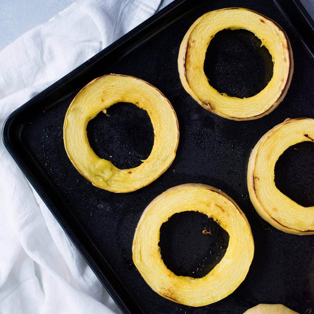 Rings of spaghetti squash roasted on a pan