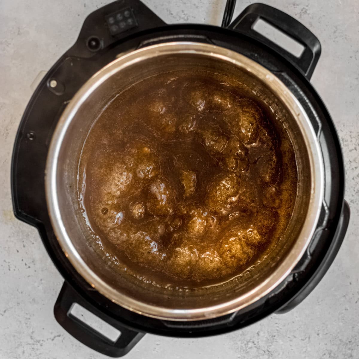 Reducing sauce for a pork roast in the Instant Pot.