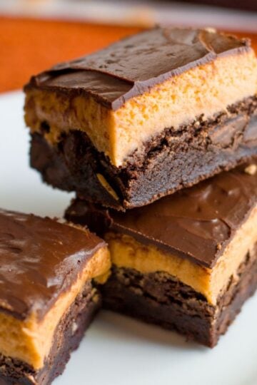 Stack of pumpkin brownies on a white plate