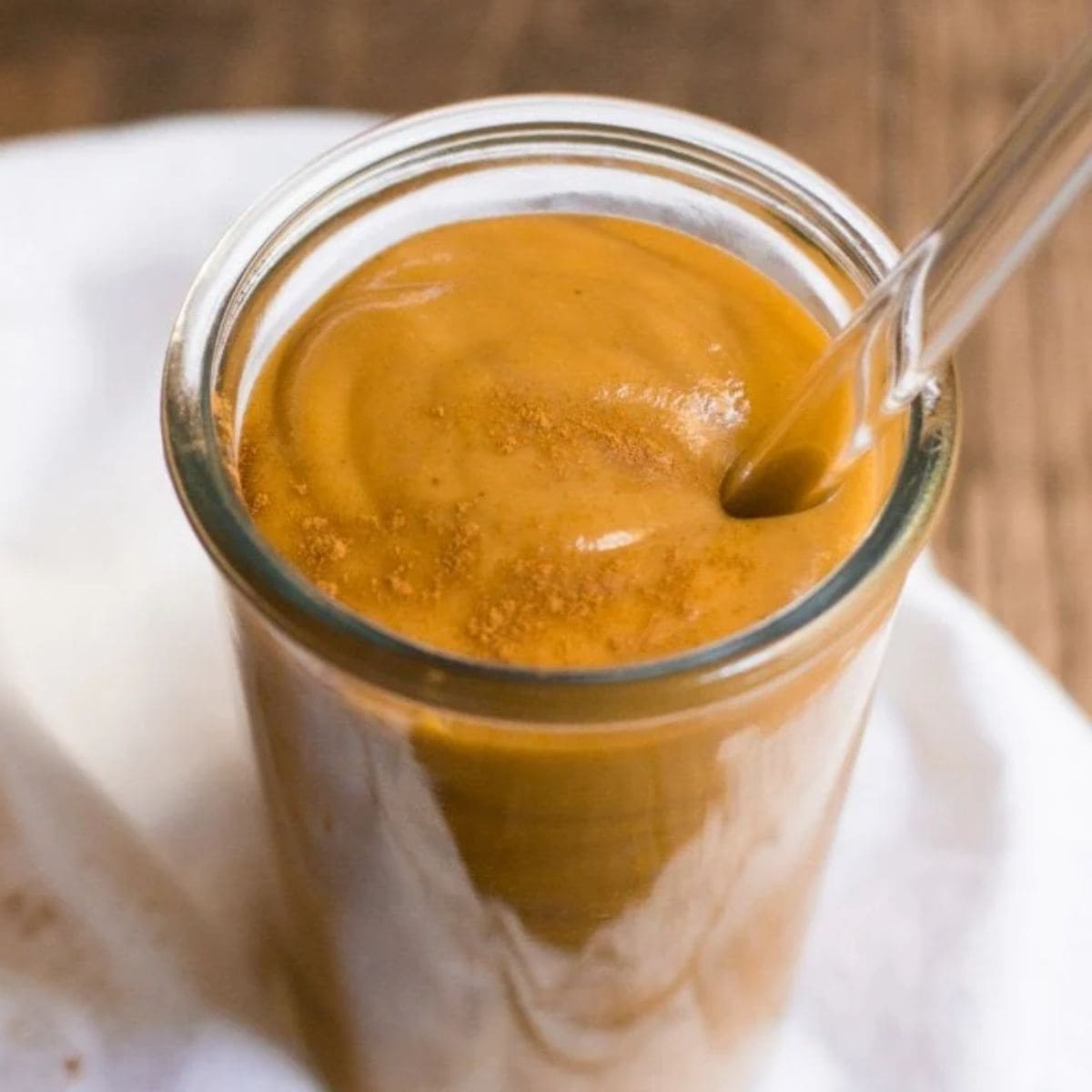 Sweet potato smoothie in a glass with a straw