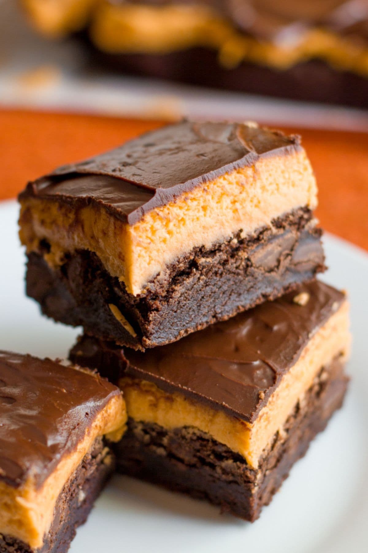 Two Halloween pumpkin brownies stacked on top of each other