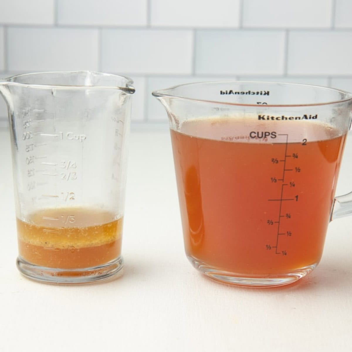 Turkey drippings with the fat in one measuring cup, and the broth in a glass measuring cup.