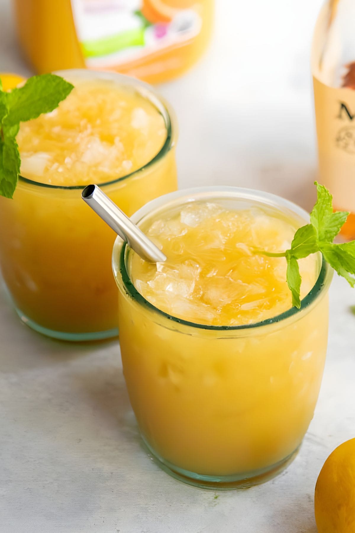 Two glasses of whiskey punch with crushed ice, garnished with mint sprigs.