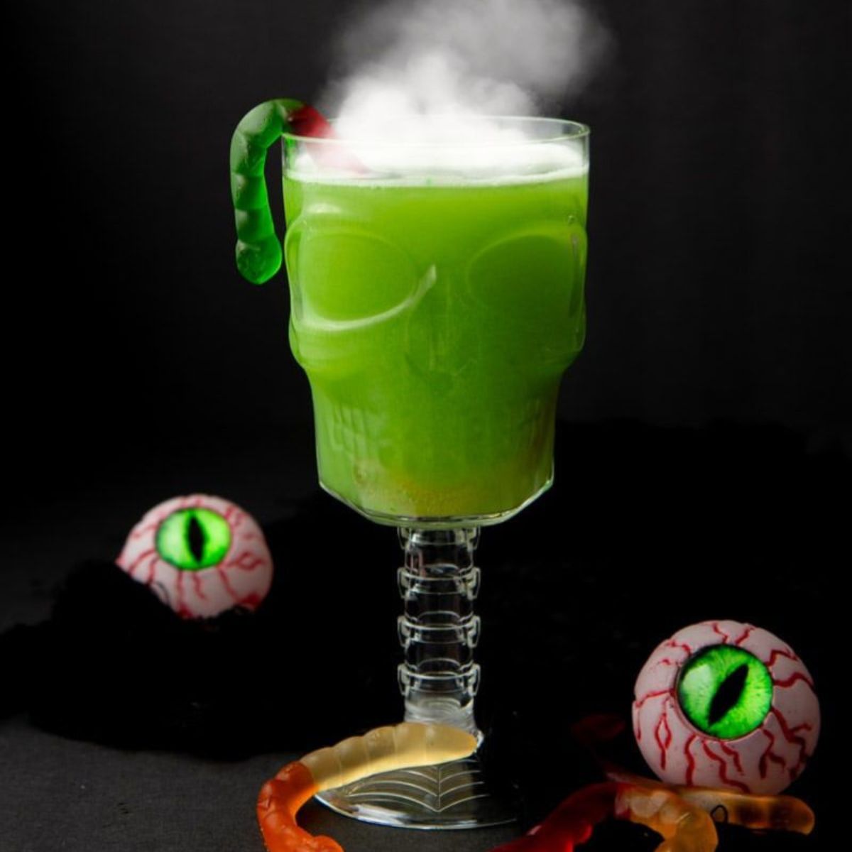 Witches' Brew Punch in a skull-shaped glass with smoke coming off the top