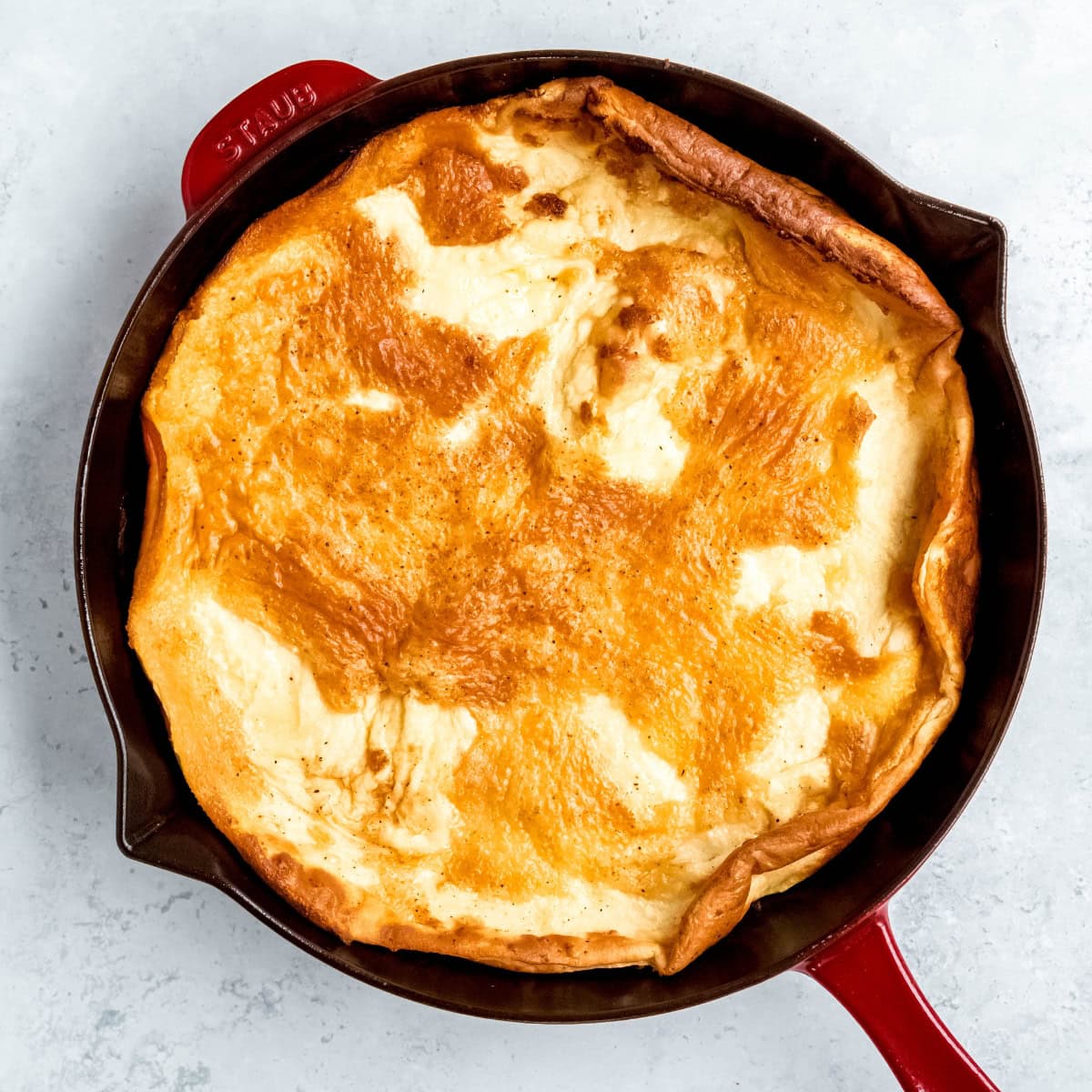 A pannukakku in a skillet, fresh out of the oven.