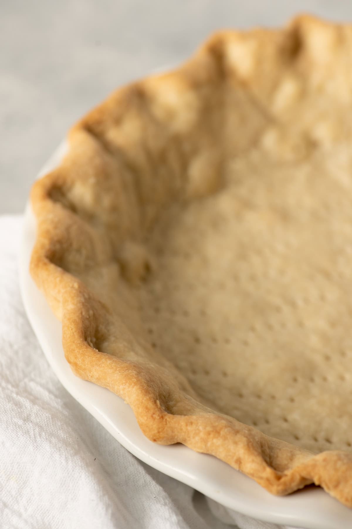 A fluted all-butter pie crust after blind baking.