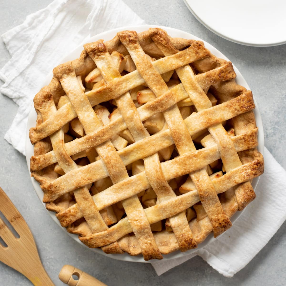A baked apple pie with an all-butter pie crust, with a lattice top.