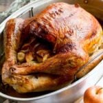 A roasted dry brined turkey on a roasting pan.