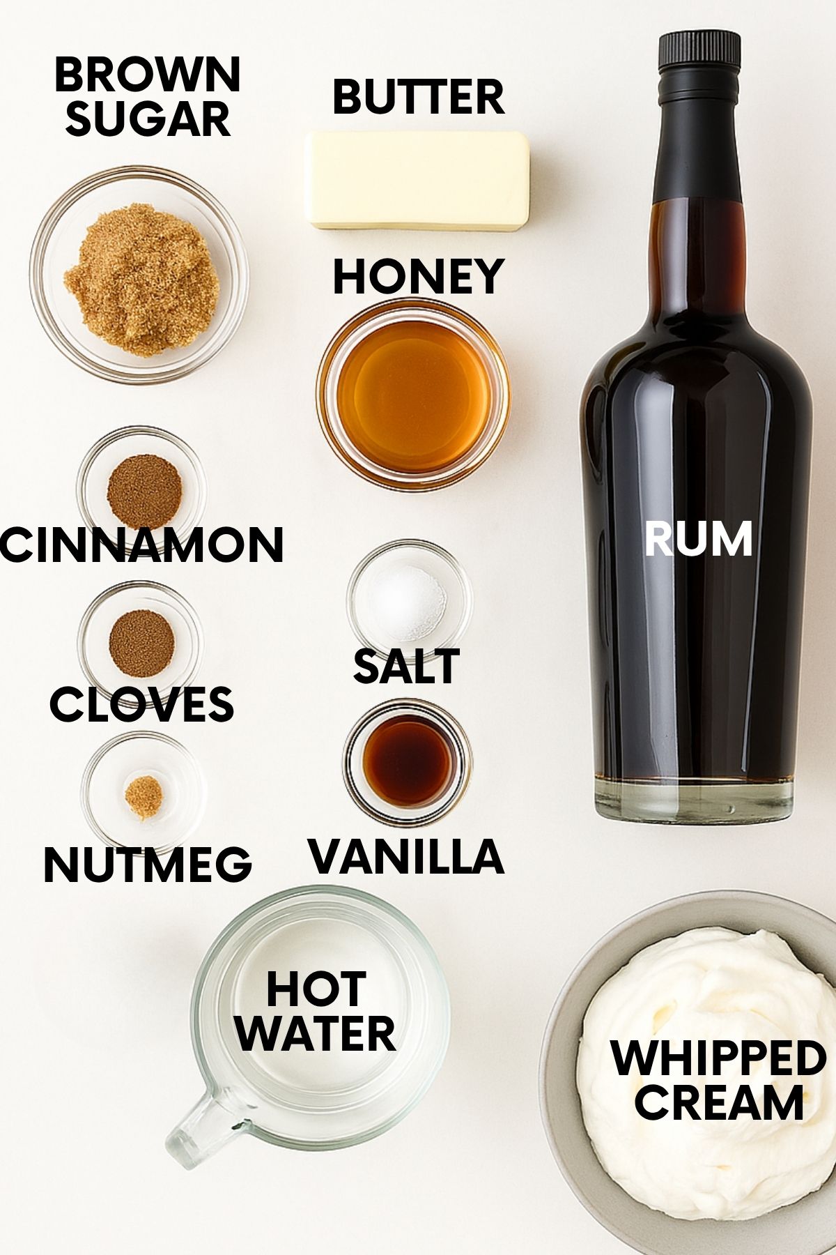 Ingredients for a hot buttered rum recipe: rum, brown sugar, butter, honey, salt, vanilla, spices, hot water, whipped cream.