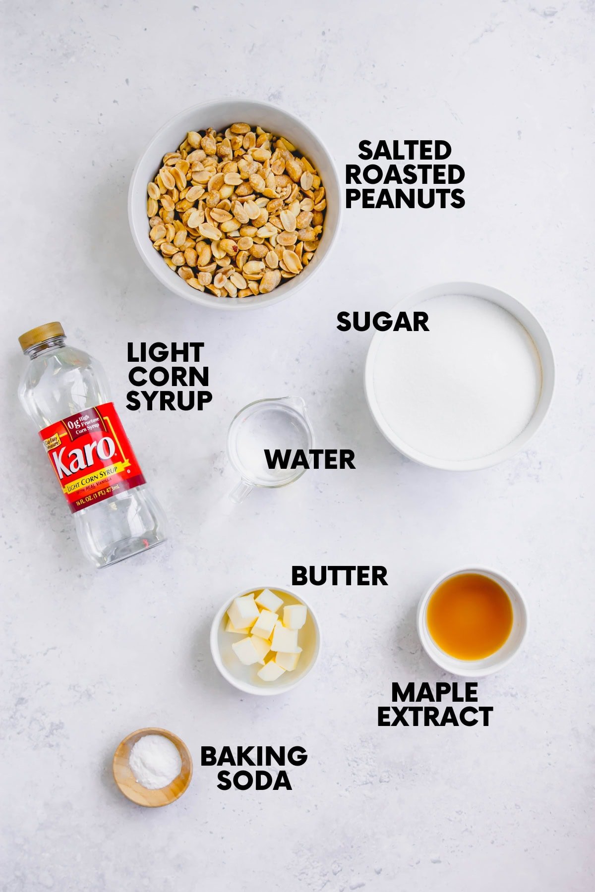 Ingredients for how to make peanut brittle: roasted peanuts, light corn syrup, water, sugar, butter, maple extract, baking soda.