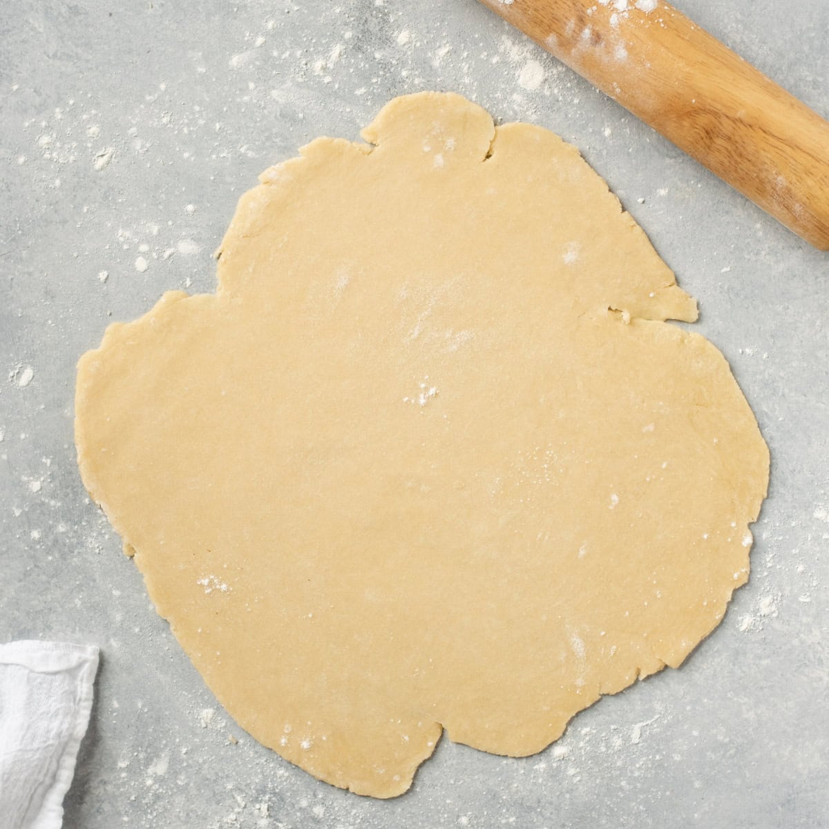 An all-butter pie crust rolled out on a floured surface.