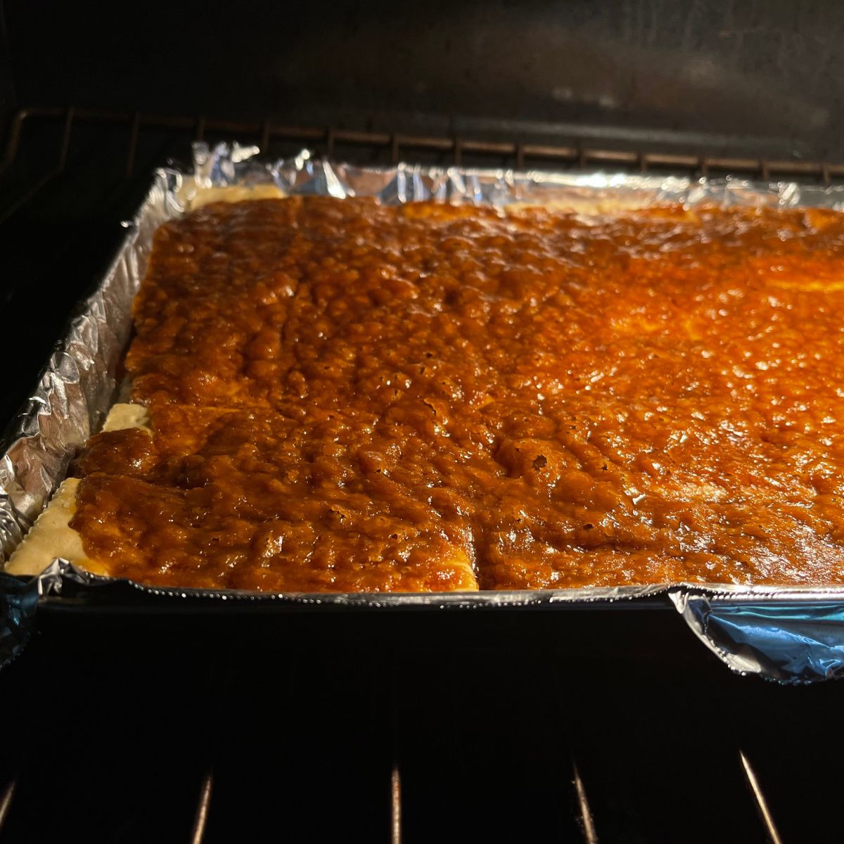 Saltine cracker toffee bakes in the oven.