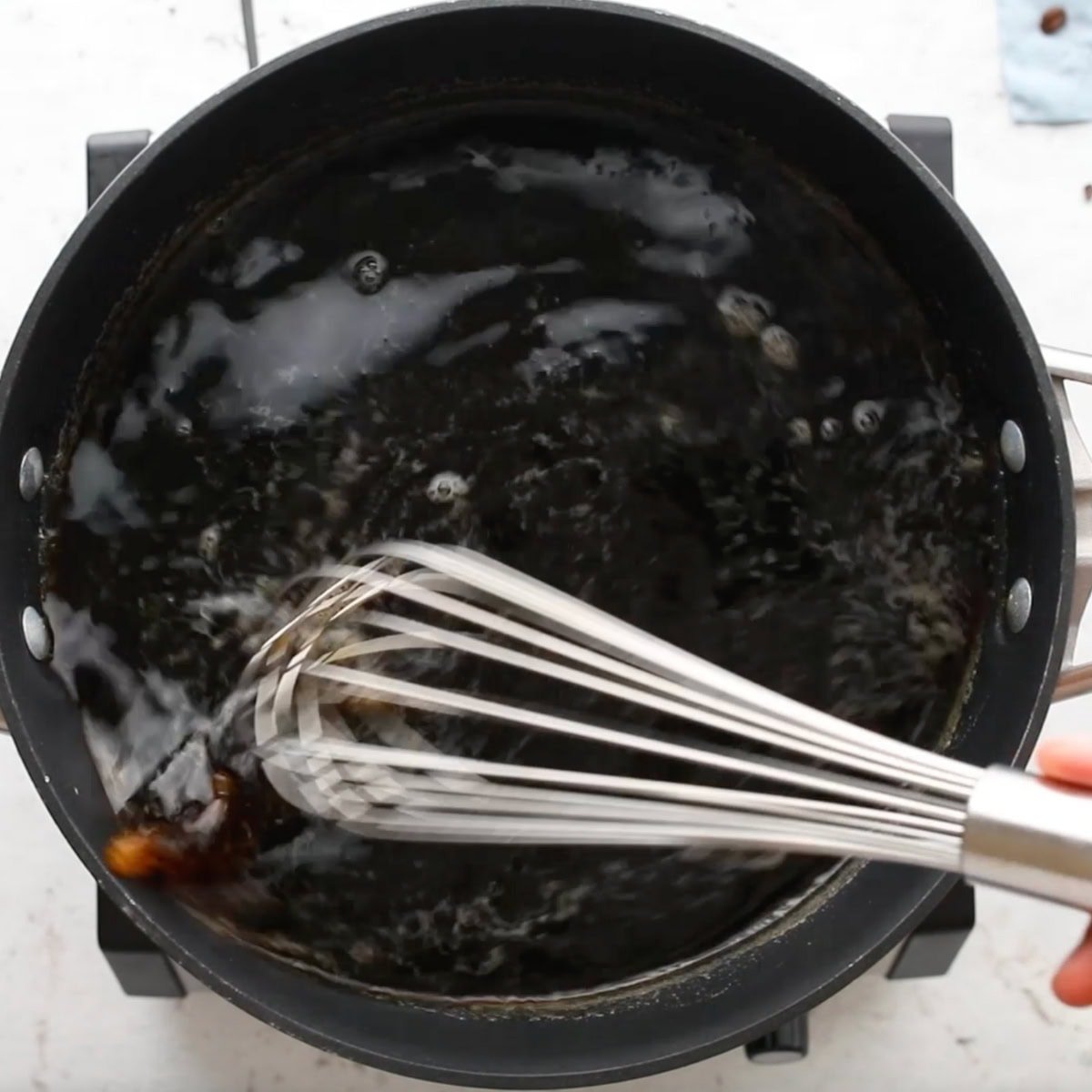 A whisk mixes up homemade kahlua.