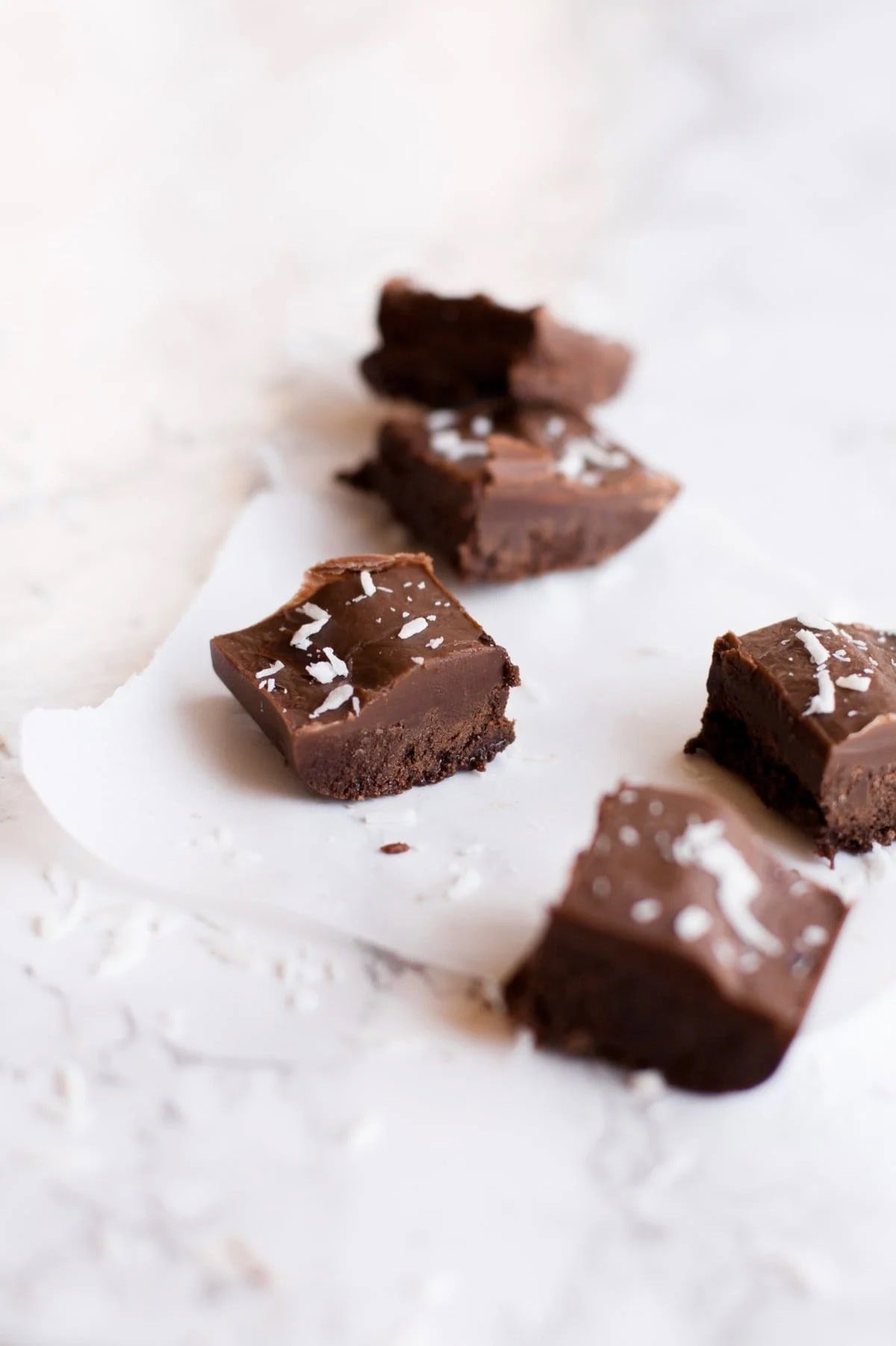 Pieces of vegan fudge with shredded coconut on top.