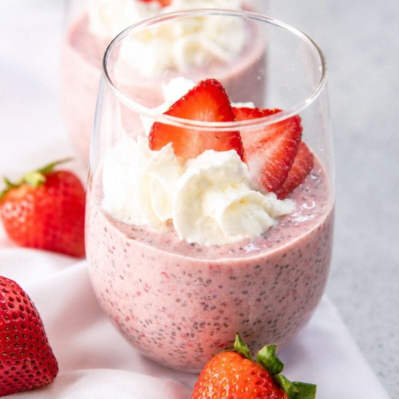 Strawberry chia seed pudding in a win glass on a counter